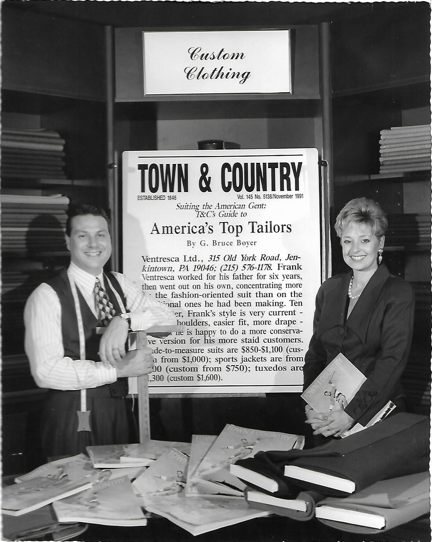 A black-and-white photo of Frank and a colleague in the store’s custom clothing corner, beside a Town & Country page titled America’s Top Tailors