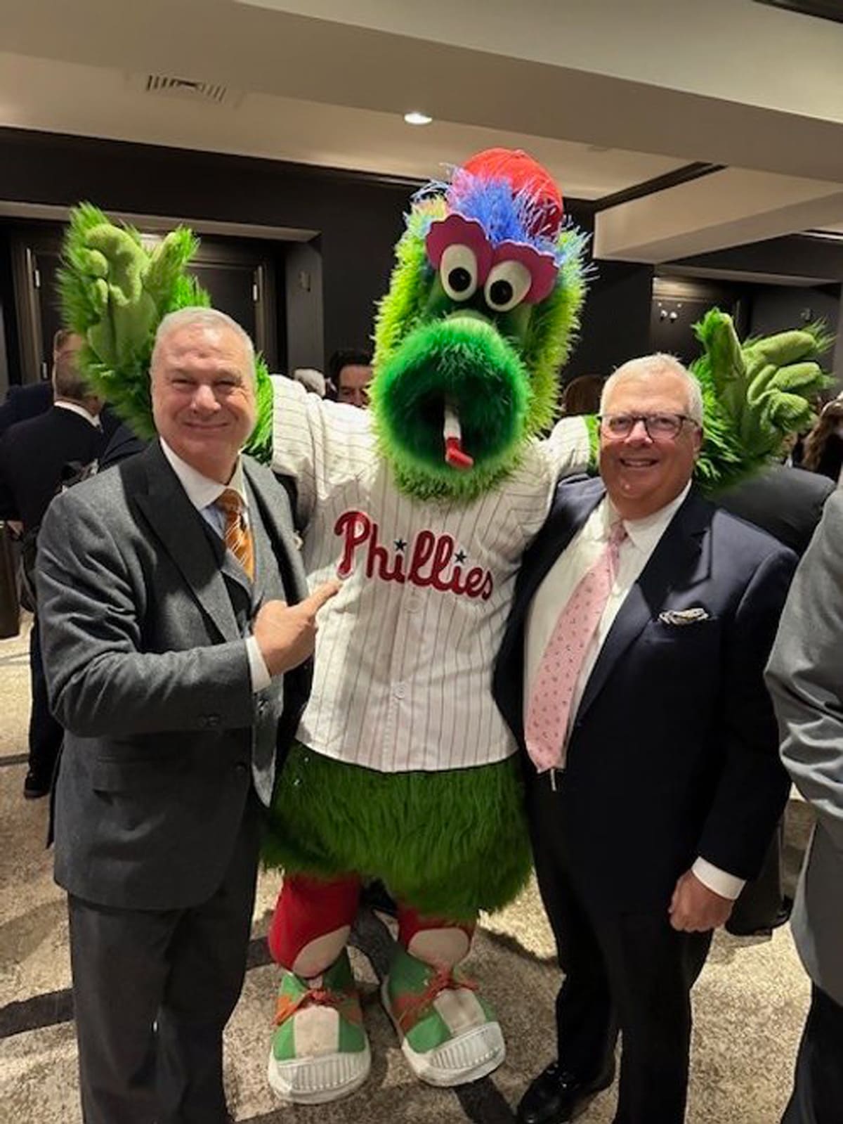 The Phillie Phanatic in a Phillies jersey with Ed Jordan and a member of the Ventresca Ltd. team