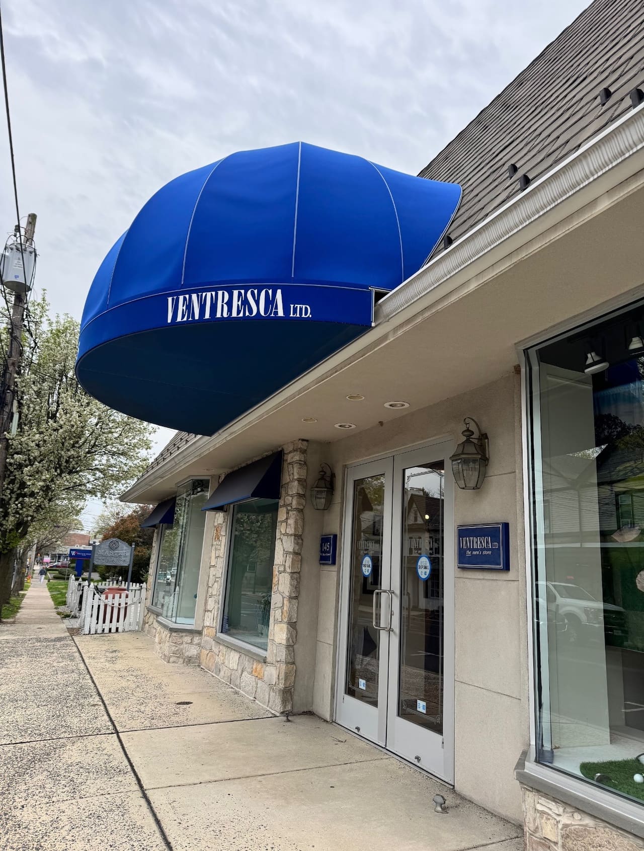 The Ventresca Ltd. front door on West State Street, under a round blue awning with the store's name, seen from the sidewalk