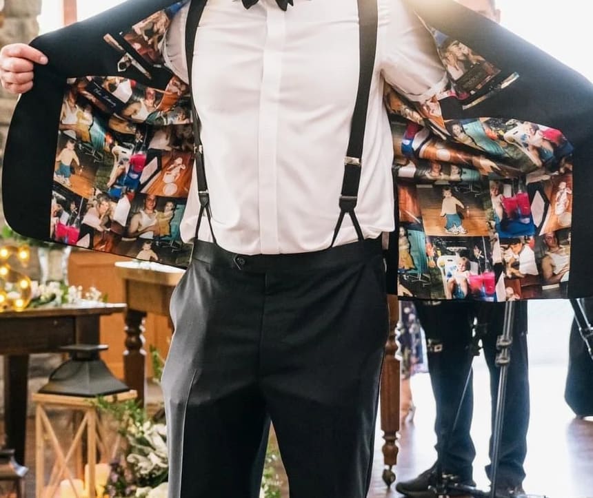 A groom holding his tuxedo jacket open to show a lining printed with family and wedding photos