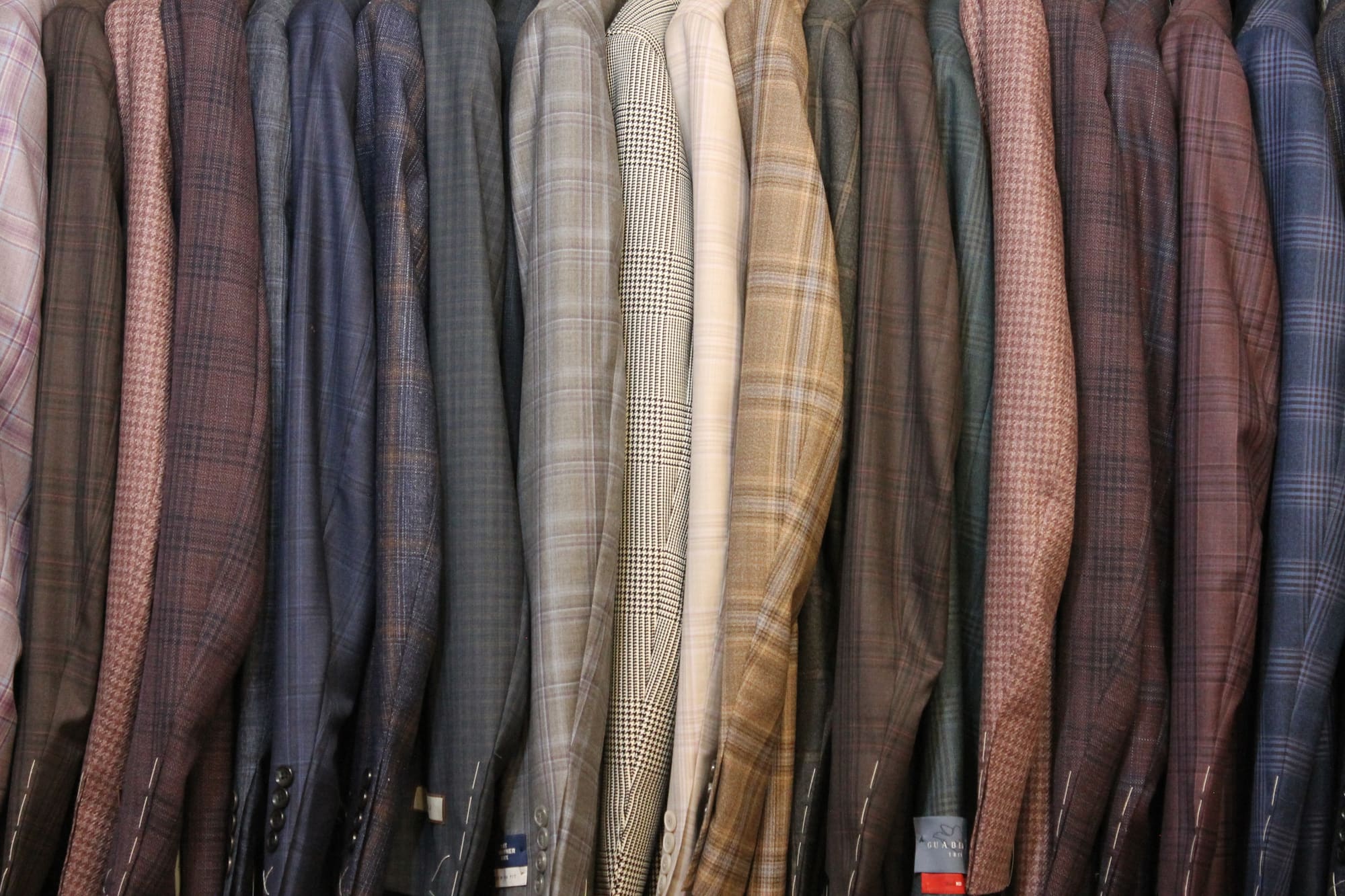 A close-up of a rack of sport coats in plaids, checks and windowpanes